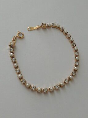 Dainty gold tone tennis bracelet with alternating faux pearl and diamonds
